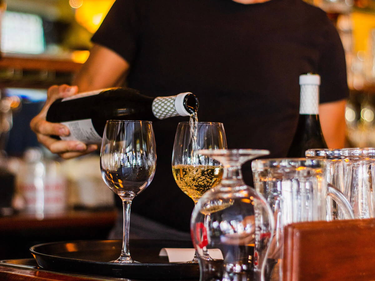 louis-hansel-sommelier-pouring-white-wine-woman